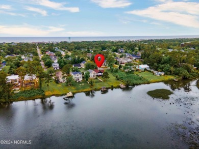 Experience waterfront living at its finest at 5802 E Yacht Drive on Founders Club At St. James Plantation in North Carolina - for sale on GolfHomes.com, golf home, golf lot