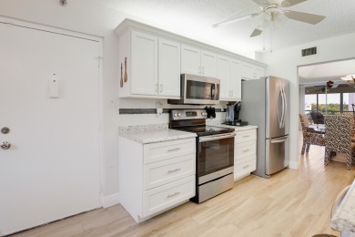 WELCOME TO THIS SPACIOUS, ATTRACTIVE CORNER, TOP FLOOR  CONDO on Poinciana Golf Club in Florida - for sale on GolfHomes.com, golf home, golf lot