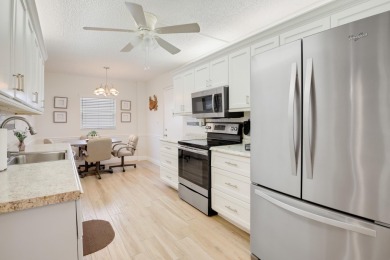 WELCOME TO THIS SPACIOUS, ATTRACTIVE CORNER, TOP FLOOR  CONDO on Poinciana Golf Club in Florida - for sale on GolfHomes.com, golf home, golf lot