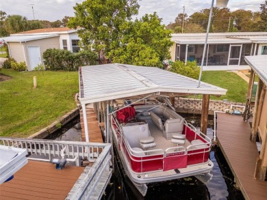 WATERFRONT 2 BED/2 BATH CORNER LOT - BOATHOUSE w/ LIFT - VIBRANT on Bay Tree Golf Course in Florida - for sale on GolfHomes.com, golf home, golf lot