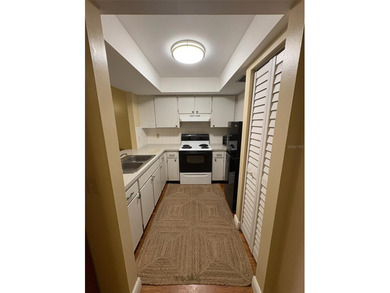 Step inside this condo and appreciate the bright, open floor on Tarpon Springs Golf Course in Florida - for sale on GolfHomes.com, golf home, golf lot