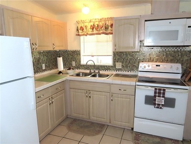 Nice 1993 home for the price in this 55 plus community of Snug on Barefoot Bay Golf Course in Florida - for sale on GolfHomes.com, golf home, golf lot