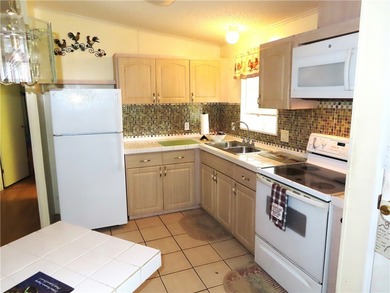 Nice 1993 home for the price in this 55 plus community of Snug on Barefoot Bay Golf Course in Florida - for sale on GolfHomes.com, golf home, golf lot