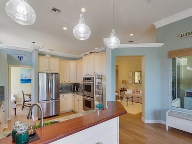 This pool home features a 2022 roof, laminate flooring on The Legacy Golf and Tennis Club in Florida - for sale on GolfHomes.com, golf home, golf lot