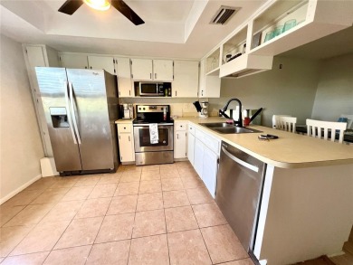 This spacious CORNER Unit located on the 14th Hole of Seven on Seven Springs Golf and Country Club in Florida - for sale on GolfHomes.com, golf home, golf lot