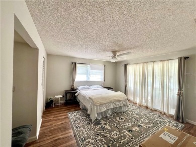 This spacious CORNER Unit located on the 14th Hole of Seven on Seven Springs Golf and Country Club in Florida - for sale on GolfHomes.com, golf home, golf lot