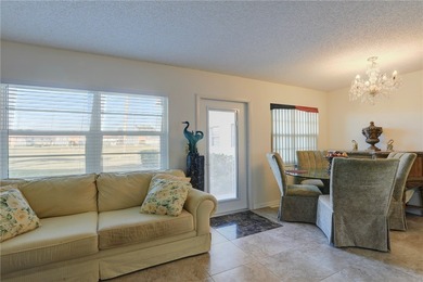 Charming first-floor condo with golf and green space views plus on The American Golf Club in Florida - for sale on GolfHomes.com, golf home, golf lot