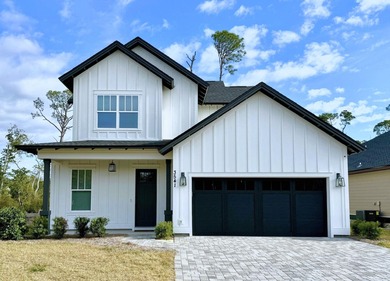 Stunning 2-story home in Sanctuary Beach gated community in on Bay Point Resort Golf Club in Florida - for sale on GolfHomes.com, golf home, golf lot