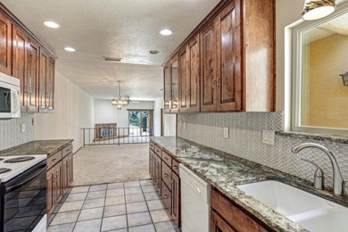 This lovely townhome in sought after Chimney Ridge sits directly on Arroyo Del Oso Golf Course in New Mexico - for sale on GolfHomes.com, golf home, golf lot