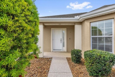 Welcome to this beautifully maintained Challedon model home in on Eagle Ridge At Spruce Creek Country Club in Florida - for sale on GolfHomes.com, golf home, golf lot