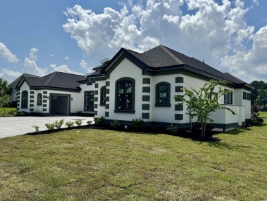 Welcome to 1261 Wood Stork Dr., a stunning new construction on Wild Wing Plantation in South Carolina - for sale on GolfHomes.com, golf home, golf lot
