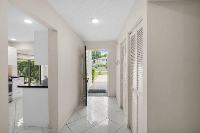 Enjoy serene water views from this light and bright first-floor on Hunters Run Golf and Country Club in Florida - for sale on GolfHomes.com, golf home, golf lot