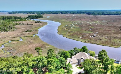 Welcome to this exquisite riverfront property, located in a golf on Carolina National Golf Club in North Carolina - for sale on GolfHomes.com, golf home, golf lot