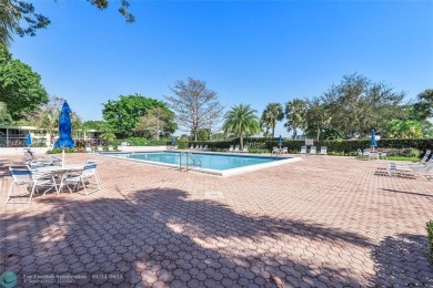 Nestled in a charming five-story condo community, this home on Palm-Aire Country Club and Resort - Palms in Florida - for sale on GolfHomes.com, golf home, golf lot