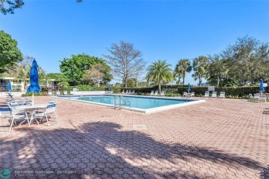 Nestled in a charming five-story condo community, this home on Palm-Aire Country Club and Resort - Palms in Florida - for sale on GolfHomes.com, golf home, golf lot