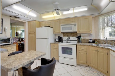 WELCOME TO THIS CONVENIENT 1ST FLOOR CONDO WITH BEAUTIFUL WATER on Poinciana Golf Club in Florida - for sale on GolfHomes.com, golf home, golf lot