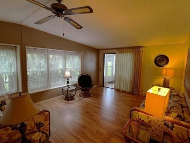 This well maintained 2 bedroom2 bath, 1988 Homes of Merit sits on Lake Henry Golf Club in Florida - for sale on GolfHomes.com, golf home, golf lot