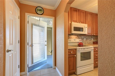 Cozy Plan B 2-bed/2-bath condo with panoramic golf and lake on The American Golf Club in Florida - for sale on GolfHomes.com, golf home, golf lot