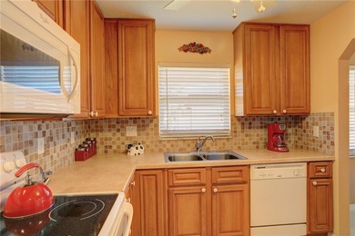 Cozy Plan B 2-bed/2-bath condo with panoramic golf and lake on The American Golf Club in Florida - for sale on GolfHomes.com, golf home, golf lot