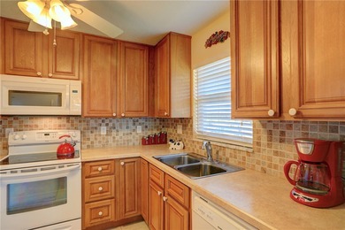 Cozy Plan B 2-bed/2-bath condo with panoramic golf and lake on The American Golf Club in Florida - for sale on GolfHomes.com, golf home, golf lot