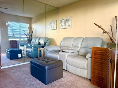 1ST FLOOR condo overlooking the fairway from the living room on The American Golf Club in Florida - for sale on GolfHomes.com, golf home, golf lot