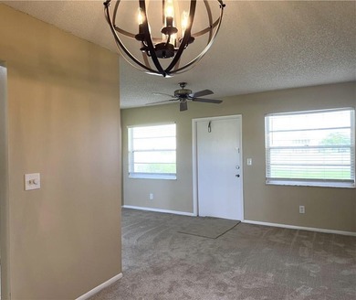 1ST FLOOR condo overlooking the fairway from the living room on The American Golf Club in Florida - for sale on GolfHomes.com, golf home, golf lot