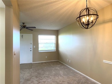 1ST FLOOR condo overlooking the fairway from the living room on The American Golf Club in Florida - for sale on GolfHomes.com, golf home, golf lot