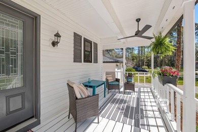 This charming, updated home with a wraparound front porch is on Lake Forest Yacht and Country Club in Alabama - for sale on GolfHomes.com, golf home, golf lot