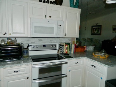 This 26x48 1984 Ventura home is located on a coveted corner lot on Grasslands Golf and Country Club in Florida - for sale on GolfHomes.com, golf home, golf lot