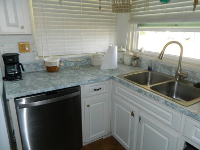 This 26x48 1984 Ventura home is located on a coveted corner lot on Grasslands Golf and Country Club in Florida - for sale on GolfHomes.com, golf home, golf lot