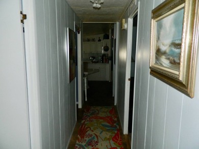 This 26x48 1984 Ventura home is located on a coveted corner lot on Grasslands Golf and Country Club in Florida - for sale on GolfHomes.com, golf home, golf lot