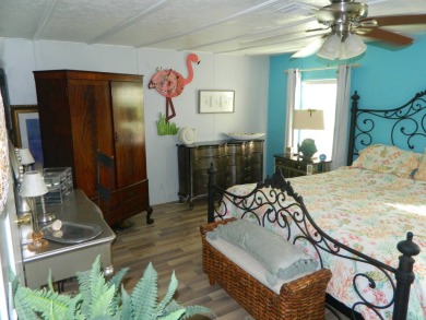 This 26x48 1984 Ventura home is located on a coveted corner lot on Grasslands Golf and Country Club in Florida - for sale on GolfHomes.com, golf home, golf lot