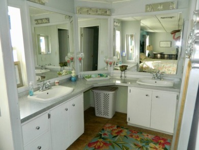 This 26x48 1984 Ventura home is located on a coveted corner lot on Grasslands Golf and Country Club in Florida - for sale on GolfHomes.com, golf home, golf lot