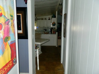 This 26x48 1984 Ventura home is located on a coveted corner lot on Grasslands Golf and Country Club in Florida - for sale on GolfHomes.com, golf home, golf lot