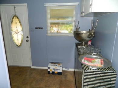 This 26x48 1984 Ventura home is located on a coveted corner lot on Grasslands Golf and Country Club in Florida - for sale on GolfHomes.com, golf home, golf lot