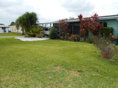 This 26x48 1984 Ventura home is located on a coveted corner lot on Grasslands Golf and Country Club in Florida - for sale on GolfHomes.com, golf home, golf lot