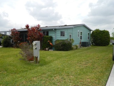 This 26x48 1984 Ventura home is located on a coveted corner lot on Grasslands Golf and Country Club in Florida - for sale on GolfHomes.com, golf home, golf lot