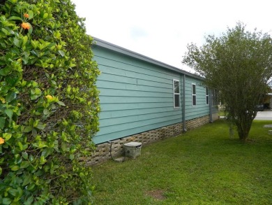 This 26x48 1984 Ventura home is located on a coveted corner lot on Grasslands Golf and Country Club in Florida - for sale on GolfHomes.com, golf home, golf lot