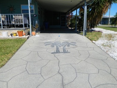 This 26x48 1984 Ventura home is located on a coveted corner lot on Grasslands Golf and Country Club in Florida - for sale on GolfHomes.com, golf home, golf lot