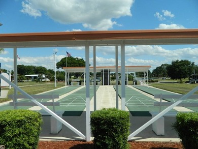 This 26x48 1984 Ventura home is located on a coveted corner lot on Grasslands Golf and Country Club in Florida - for sale on GolfHomes.com, golf home, golf lot