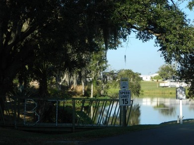 This 26x48 1984 Ventura home is located on a coveted corner lot on Grasslands Golf and Country Club in Florida - for sale on GolfHomes.com, golf home, golf lot