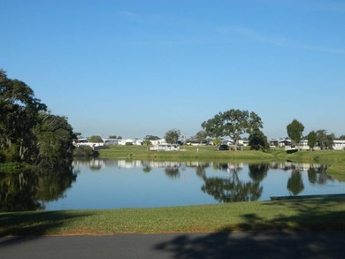 This 26x48 1984 Ventura home is located on a coveted corner lot on Grasslands Golf and Country Club in Florida - for sale on GolfHomes.com, golf home, golf lot