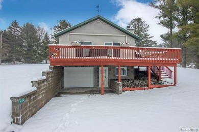 Welcome to this inviting raised ranch style home nestled within on Lost Lake Woods Club in Michigan - for sale on GolfHomes.com, golf home, golf lot