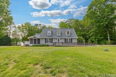 Enjoy main lake views and water-access living from this cape cod on Tanglewood Shores Golf Club in Virginia - for sale on GolfHomes.com, golf home, golf lot