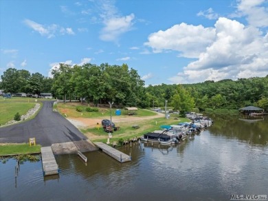 Lake life made easy--and fun! This Lake Gaston camper sits on a on River Ridge Golf Club in Virginia - for sale on GolfHomes.com, golf home, golf lot
