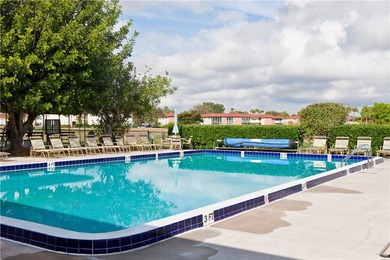 Enjoy easy Florida living in this 2BR/2BA FIRST-FLOOR unit with on The American Golf Club in Florida - for sale on GolfHomes.com, golf home, golf lot