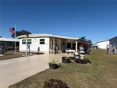 *Home Sweet Home*.Custom painted driveway flows into carport on Barefoot Bay Golf Course in Florida - for sale on GolfHomes.com, golf home, golf lot