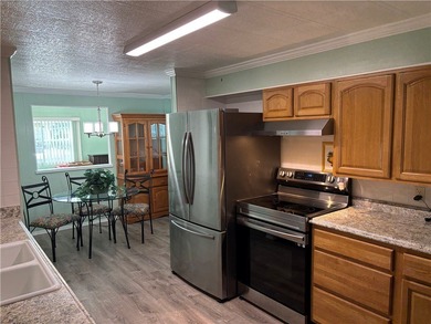 *Home Sweet Home*.Custom painted driveway flows into carport on Barefoot Bay Golf Course in Florida - for sale on GolfHomes.com, golf home, golf lot