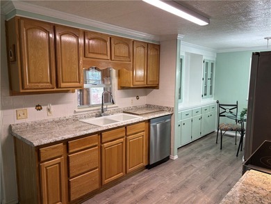 *Home Sweet Home*.Custom painted driveway flows into carport on Barefoot Bay Golf Course in Florida - for sale on GolfHomes.com, golf home, golf lot