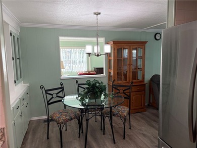 *Home Sweet Home*.Custom painted driveway flows into carport on Barefoot Bay Golf Course in Florida - for sale on GolfHomes.com, golf home, golf lot